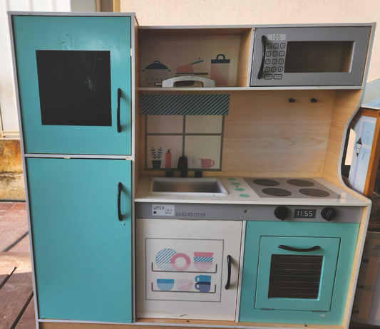 Home corner kitchenette with sink,  oven, cook top, microwave, fridge,  cupboards.